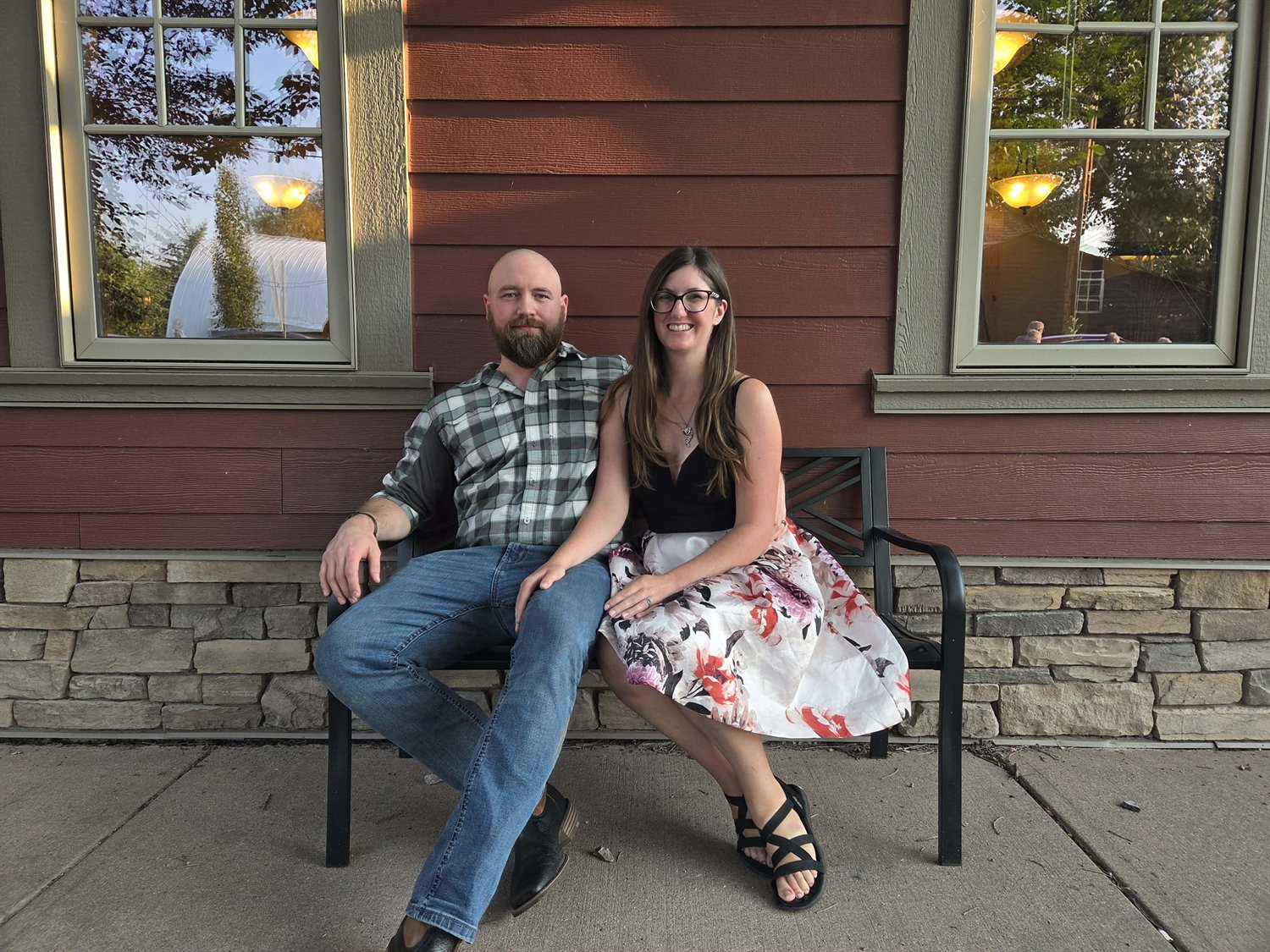 TJ Schmidt and his wife seated together outdoors